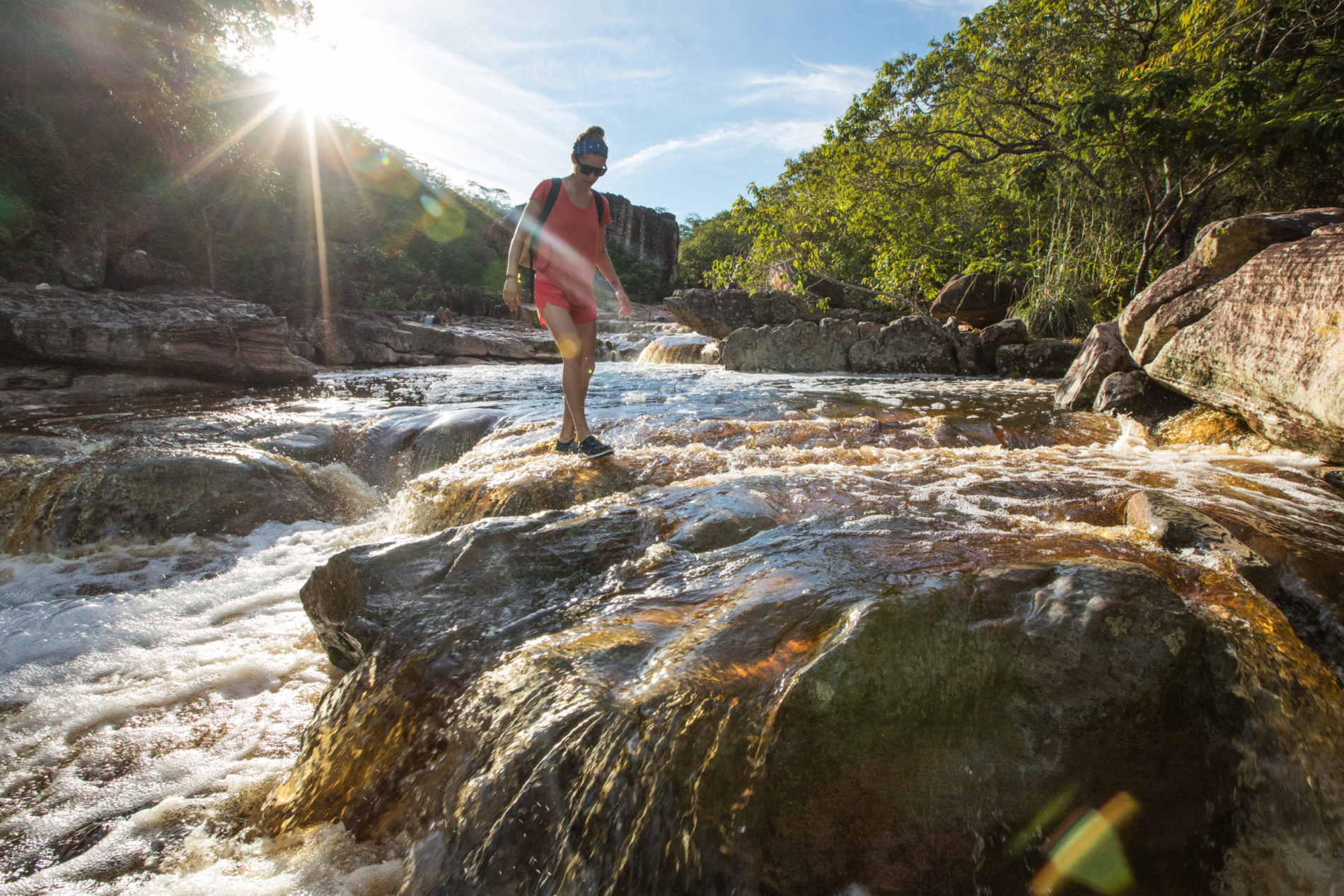 woman walking through a creek